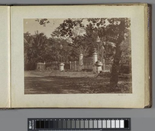 Entrance gate with lanterns in a wooded area, possibly in the Philippines