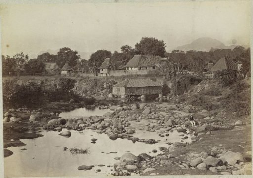 Houses by a rocky riverbed with a European on the right, possibly in the Philippines