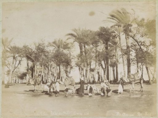 Women and children fill water jugs on the banks of the Nile near Cairo