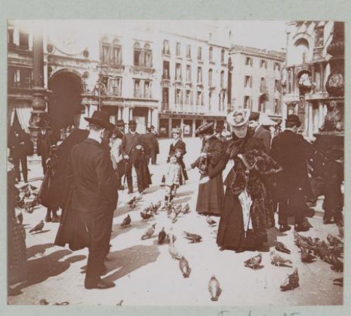 Women and children feeding pigeons on St. Mark's Square in Venice