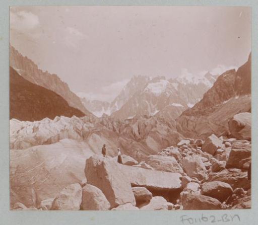 Man and woman amidst boulders and mountains in the Alps