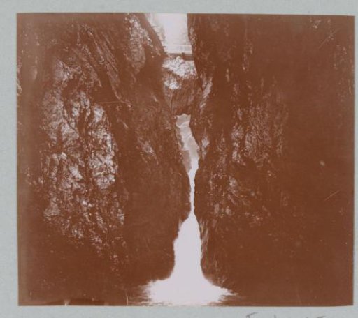Waterfall with a Bridge in the Alps