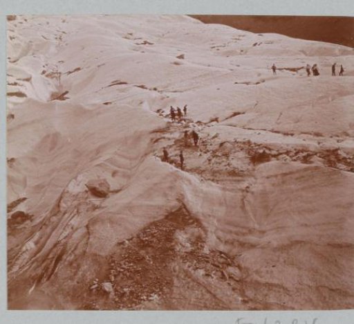 Hikers on Snowy Mountain Flanks in the Alps