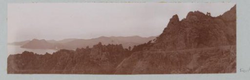 Mountain landscape with bare rocks by the sea, probably in Corsica