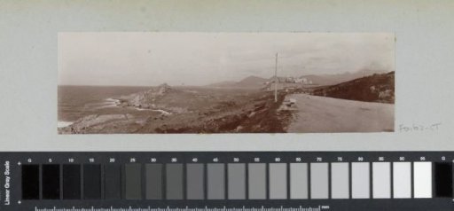 View of a coastal strip of Corsica with Calvi in the background