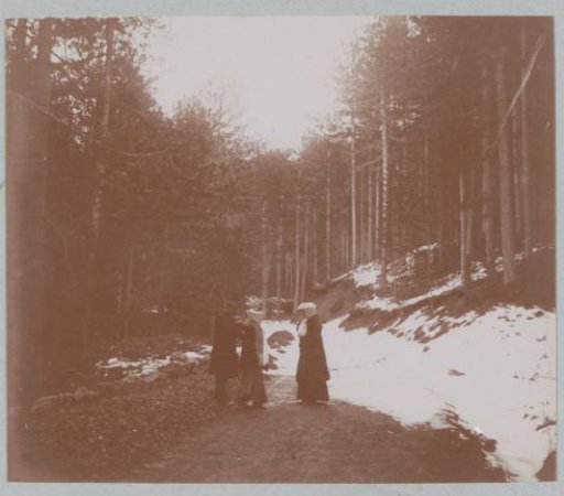 Two women and a man on a snowy mountain road, probably in Corsica