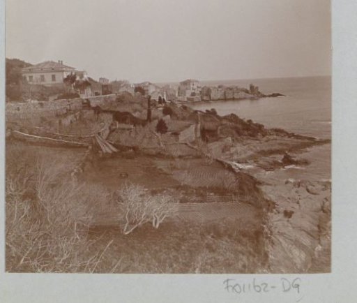View of Erbalunga on Corsica with fields and rocks in the foreground