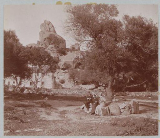 Two women and a man picnicking on rocks, presumably on Corsica