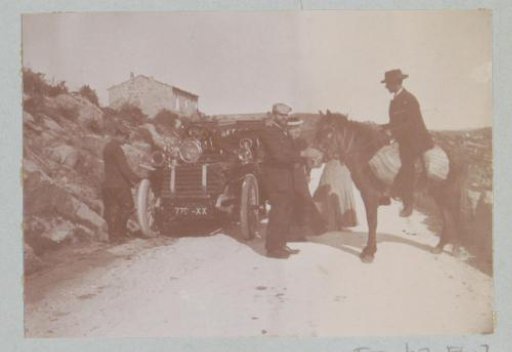 Group with a car and a rider on a road, probably in southern France