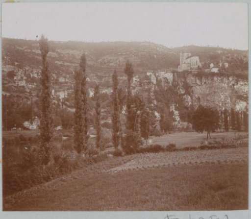 Mountainous landscape in France with fields and a church on a rock