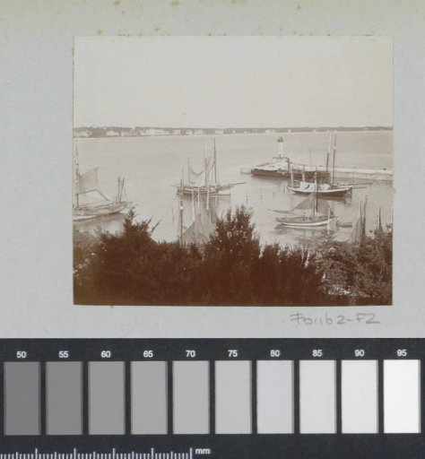 View of a harbor in France with sailing boats and a breakwater