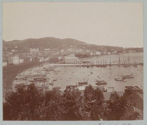 View of a probably French town with a harbor and a pier on the Mediterranean