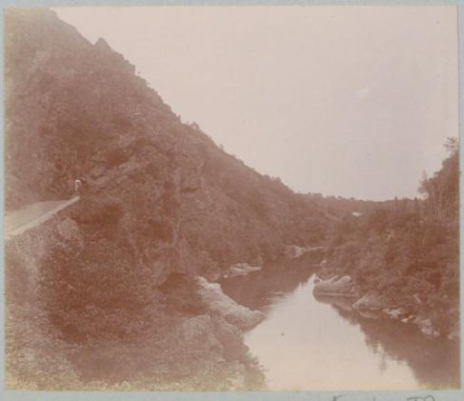 Mountain landscape with a stream and a road, probably in France