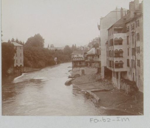 Houses on a riverbank, probably in France