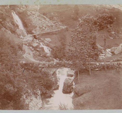 Mountain landscape with a path, a bridge and a stream, probably in the Pyrenees