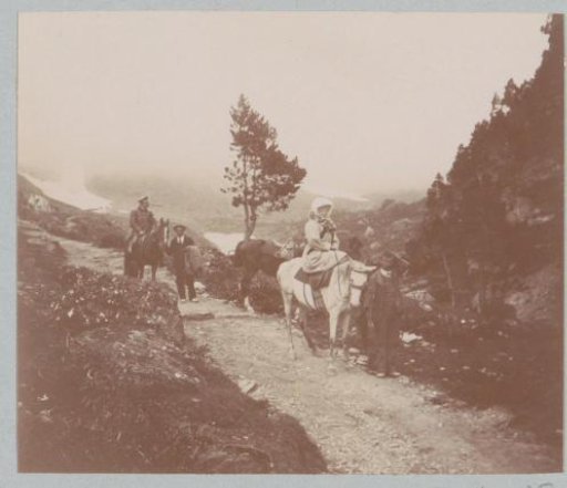 Man and woman on horseback and two guides on a path, probably in the Pyrenees