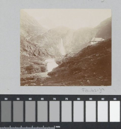 View of a mountain wall with a waterfall, probably in the Pyrenees