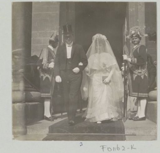 Bride and groom leaving a building, probably in Italy or France