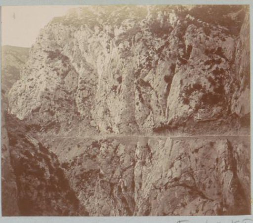 Road along a mountain wall, probably in the Pyrenees