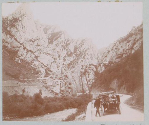 Man and a woman by a car in a mountain gorge, probably in the Pyrenees