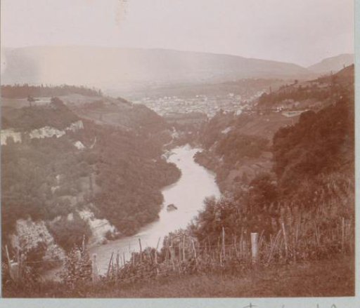 View of a river valley with a city in the background, probably in France