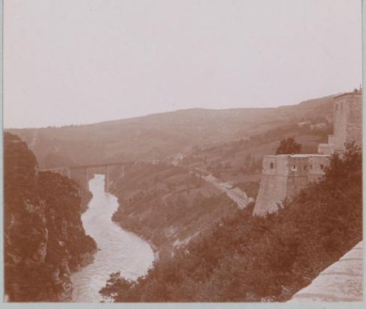 View of a river valley with a bridge, probably in France