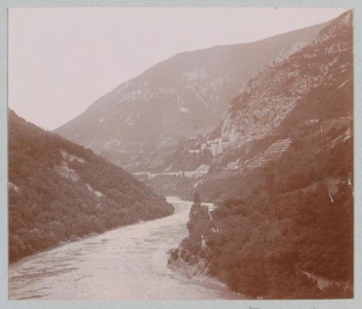 View of a river valley with a fort in the background, probably in France