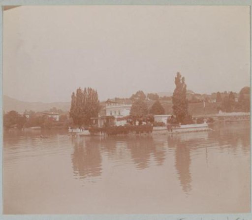 View of a villa by the water, probably in France