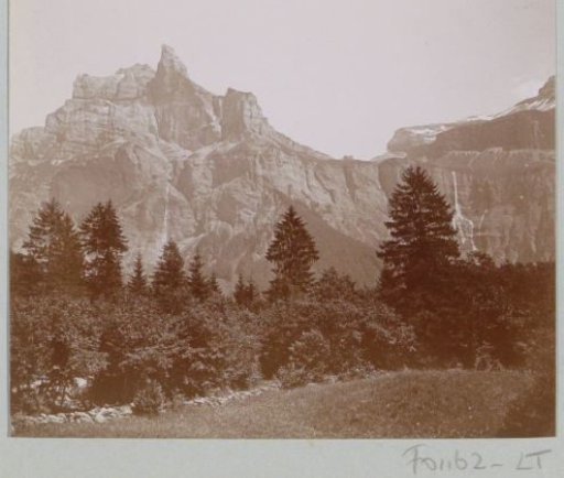 Mountain landscape with bare peaks and waterfalls in the Alps