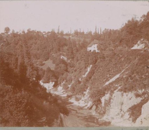 Landscape with houses along a presumably dried-up streambed