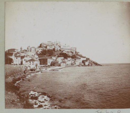 View of a town on a hill by the coast, probably in Italy
