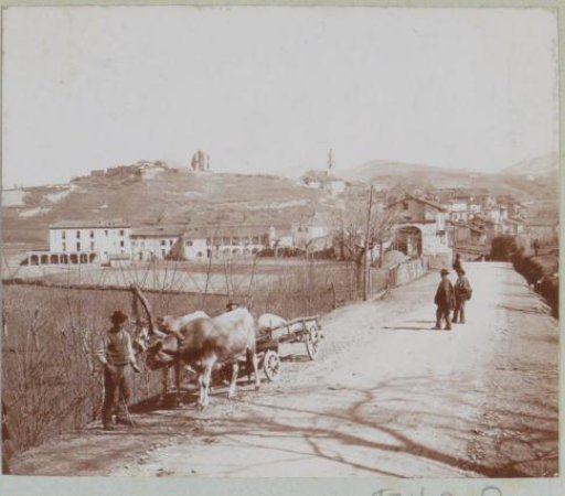 Road with an ox-cart and passers-by near a village, probably in Italy