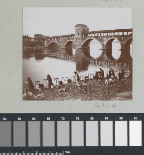View of the Ponte Coperto (Ponte Vecchio) in Pavia with women washing clothes on the bank of the Ticino in the foreground