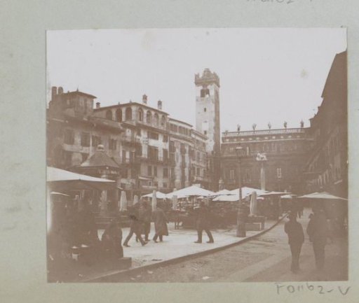 Piazza dell' Erbe in Verona with tower, terraces, and passers-by