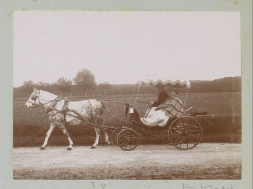 Two persons in a carriage on a country road near Coucy-le-Château