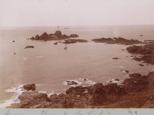 View of Rock Formations and the La Corbière Lighthouse on Jersey