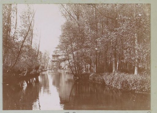 View of a waterway and trees on banks in Pacy-sur-Eure