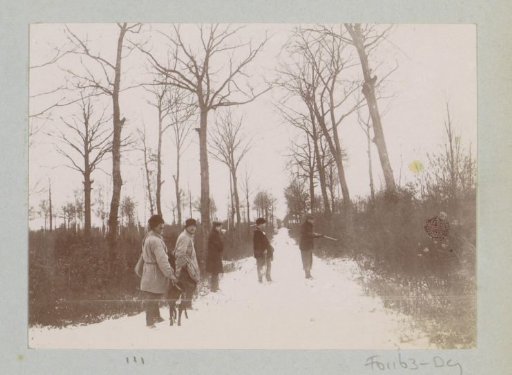 Group of hunters with dog on a snow-covered path, probably near Arcachon