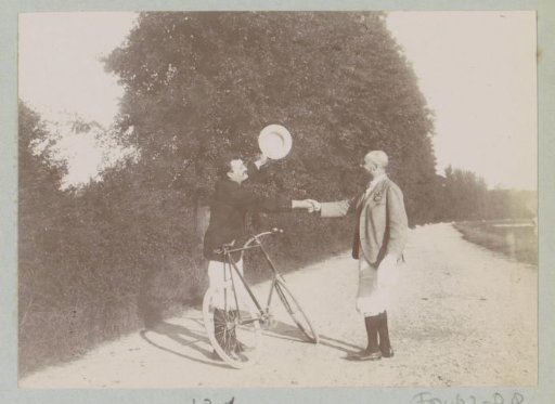 Cyclist and pedestrian shaking hands on a road at Pontoise