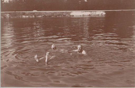 Three men swimming in a waterway at Pontoise