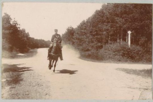 Uniformed man on horseback on a forest path, probably near Pontoise
