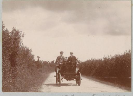 Two men in an automobile on a country road at Varaville
