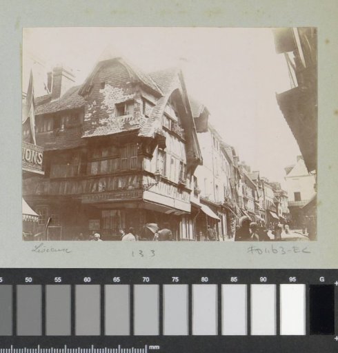 La Grande-Rue in Lisieux with a house at the corner bearing the inscription 'Plantefor Cirier'