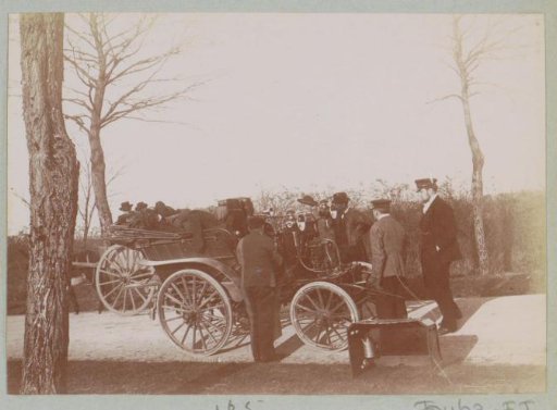 Group with an automobile on a road in France, possibly during maintenance