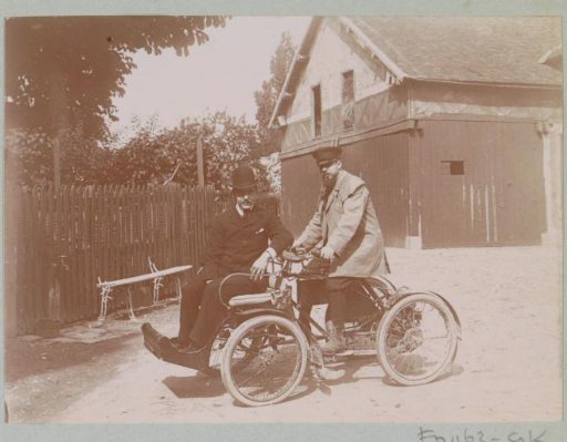 Two men on a motorized four-wheeler in France