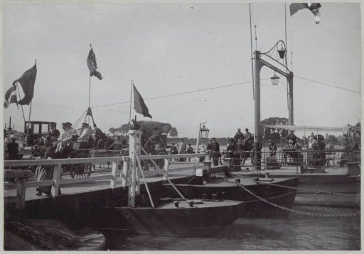 Participants in the Paris-Amsterdam race passing a pontoon bridge at Nijmegen in their automobiles