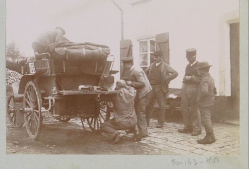 Participants in the Paris-Amsterdam race in their automobile, presumably in the Houffalize region