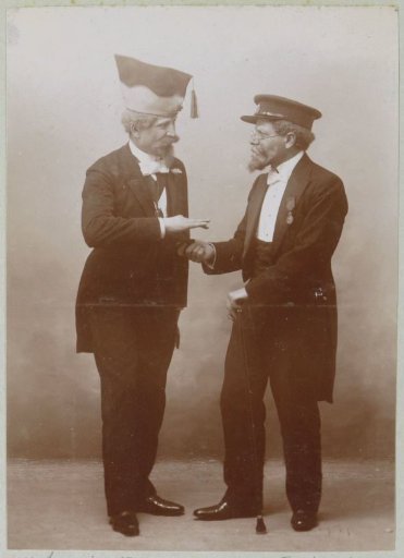 Portrait of Two Men in Festive Attire with Headgear, Probably in France