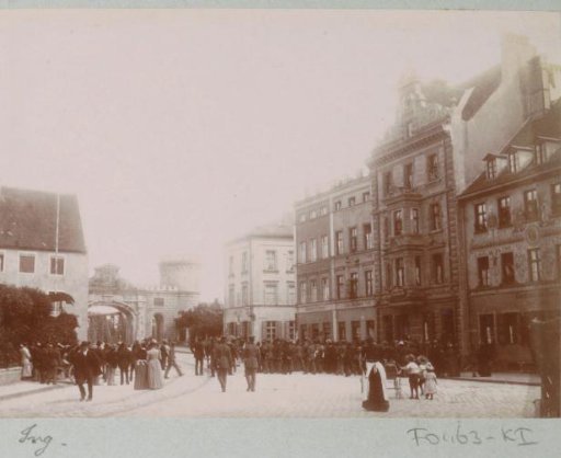 People on the Donaustrasse in Ingolstadt, with the Donautor in the background