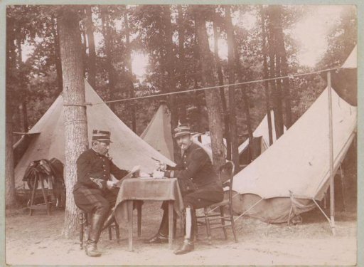 Two soldiers at a table in a military camp at Fontainebleau